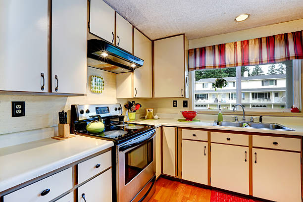 istock Simple kitchen interior with steel stove and white cabinets 508857057
