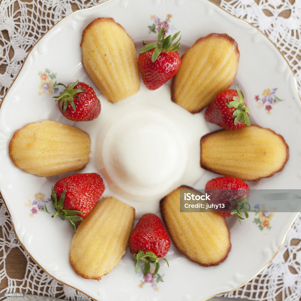 French cookies madeleine with Pannacotta French cookies madeleine with pannacotta and strawberries Afternoon Tea Stock Photo