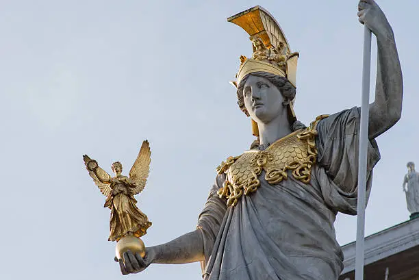 Close up of a sculpture of the Goddess of Wisdom, Athena, standing on a pillar in front of the Austrian Parliament in Vienna. 