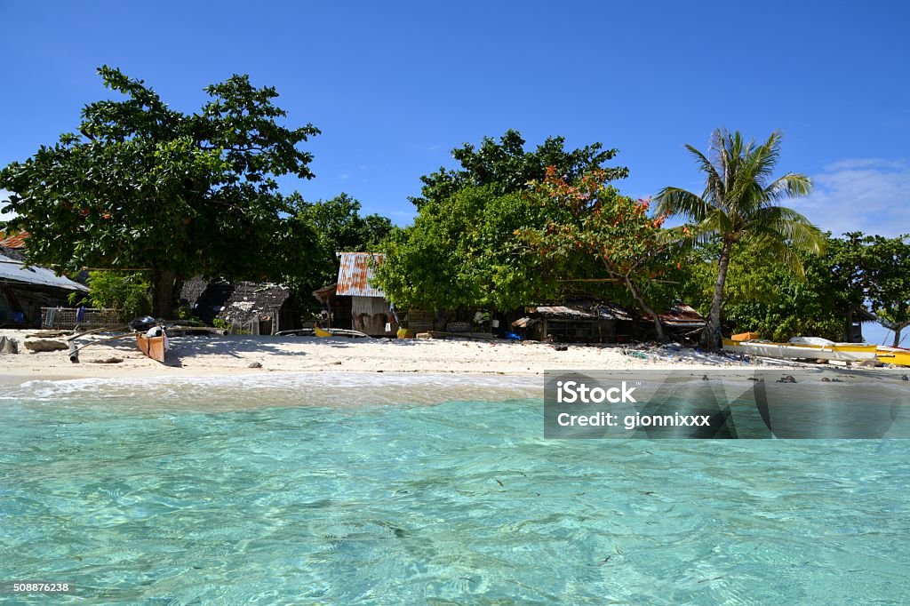 Mantigue Island, Philippines Tropical trees and stilt houses on Mantigue Island white sand beach, a idyllic small island off Camiguin coast Asia Stock Photo
