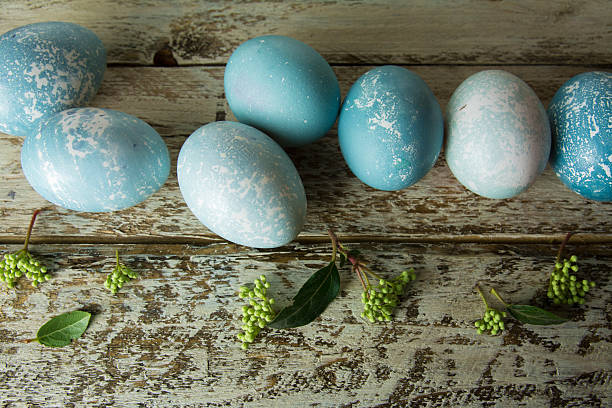 istock Blue Easter eggs and bouquet of flowers wooden table 508877122