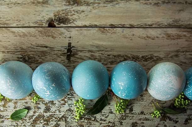 istock Blue Easter eggs and bouquet of flowers wooden table 508877206