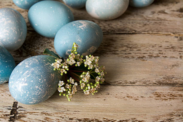 istock Blue Easter eggs and bouquet of flowers wooden table 508877392