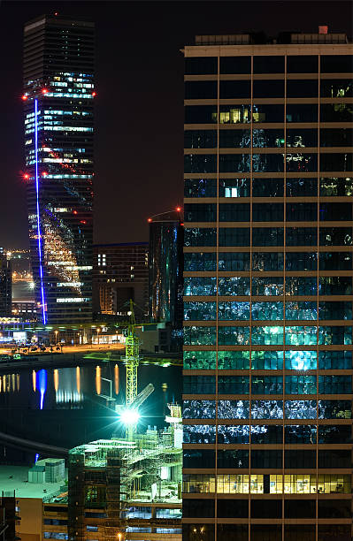 istock Office buildings in Dubai at night reflecting colorful lights 508878542