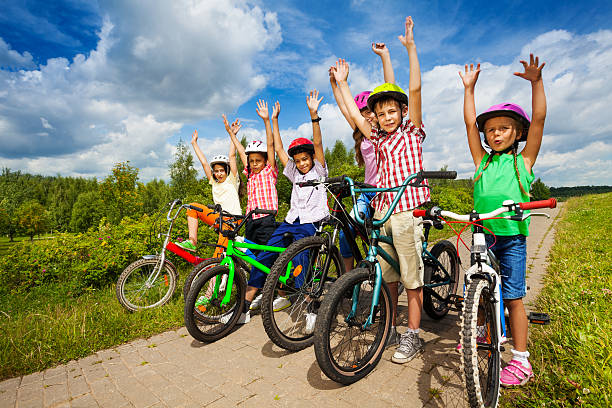 istock Children with helmets sit on their bikes in a row 508883029