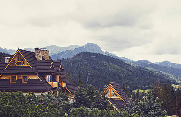 Zakopane, Poland - August 17, 2014: Mountain scene with wooden idyllic country estates with wood shingle roof in Zakopane, Poland.
