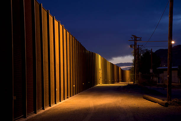 U.S. Border Fence at Night stock photo
