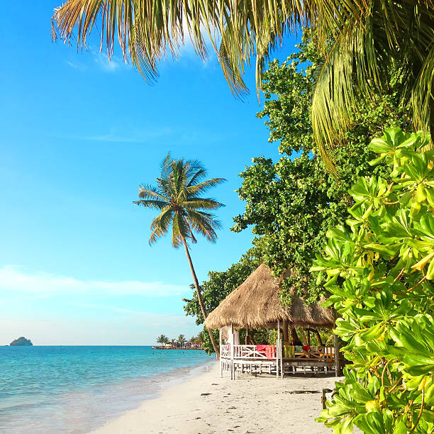 Tropical paradise with a hut on a white sand beach. Thailand, Koh Chang, Kai Bae beach.