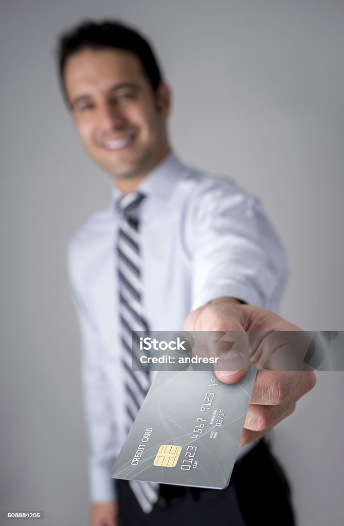 Business man holding credit card Successful business man holding credit card 20-29 Years Stock Photo