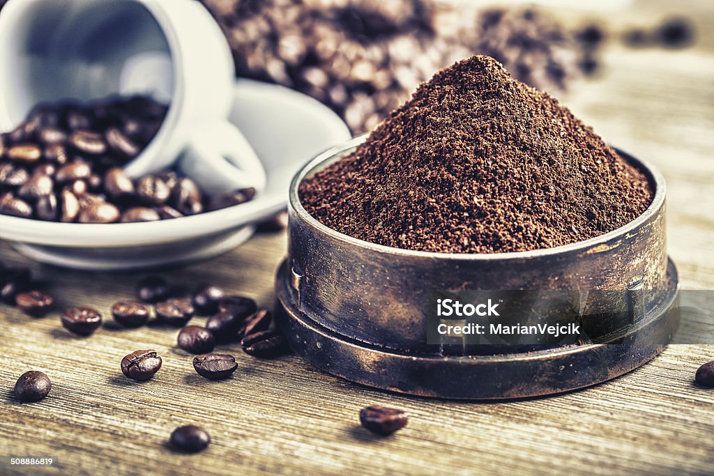 Ground coffee in an old grinder. Ground coffee in an old grinder. Old grinder,coffee beans,ground coffee and wooden ladle. Arabic Style Stock Photo