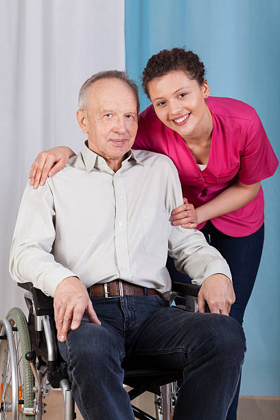istock Nurse standing by the disabled in a wheelchair 508887665
