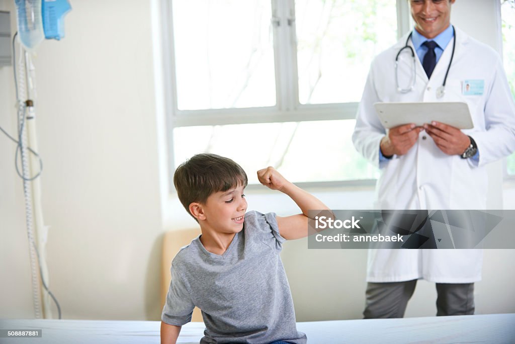 Watch my muscles grow doc! Shot of a young boy displaying his strength and bravery by flexing his arm http://195.154.178.81/DATA/istock_collage/0/shoots/784856.jpg Adult Stock Photo