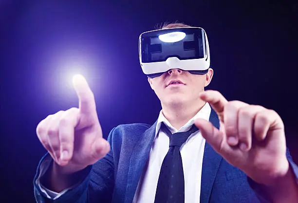 Businessman has fun using his Virtual Reality VR glasses head mounted display