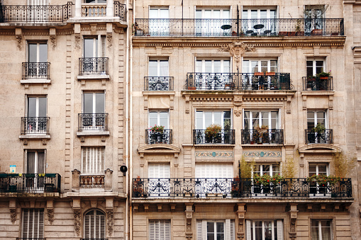 Traditional French Architecture with Typical Windows and Balconies in Paris, France. Haussmann's renovation of Paris Houses.