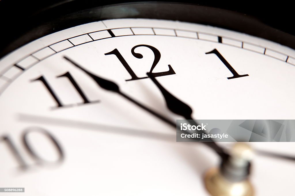 Closeup of hands on clock face Clock Stock Photo