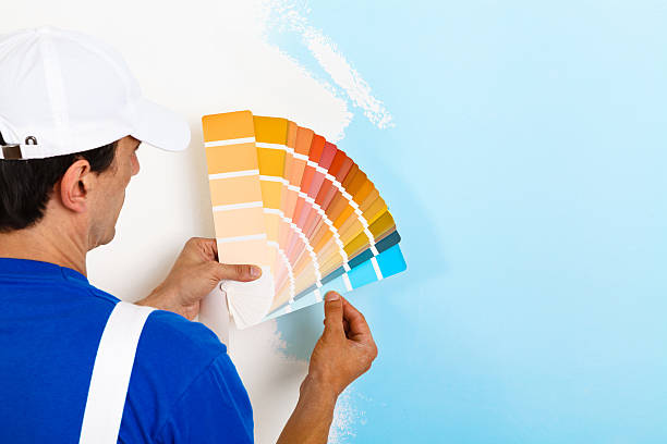 painter man looking a color palette stock photo