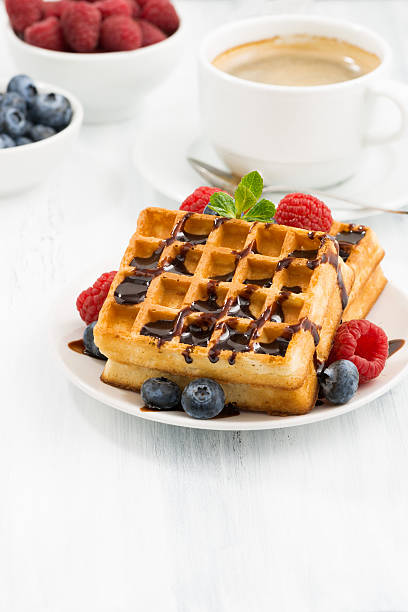 istock traditional sweet waffles with chocolate and berries, vertical 508898028