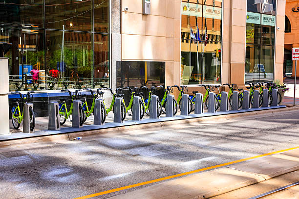 Minneapolis, MN, USA - July 26, 2015: Lime green Nice Ride rental cycles locked into a parking station in downtown Minneapolis MN