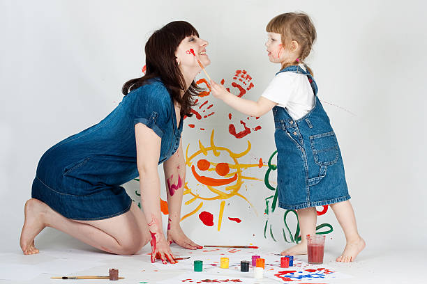 istock mother and daugher painting 508901876
