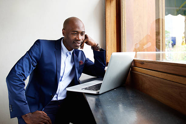 istock Businessman at a cafe looking at laptop 508902492