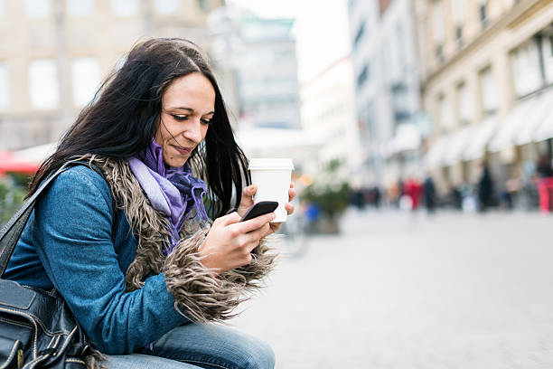istock young woman texting on her phone 508904641