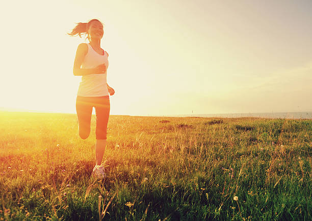 istock Runner athlete running on sunrise/sunset grass field 508905749