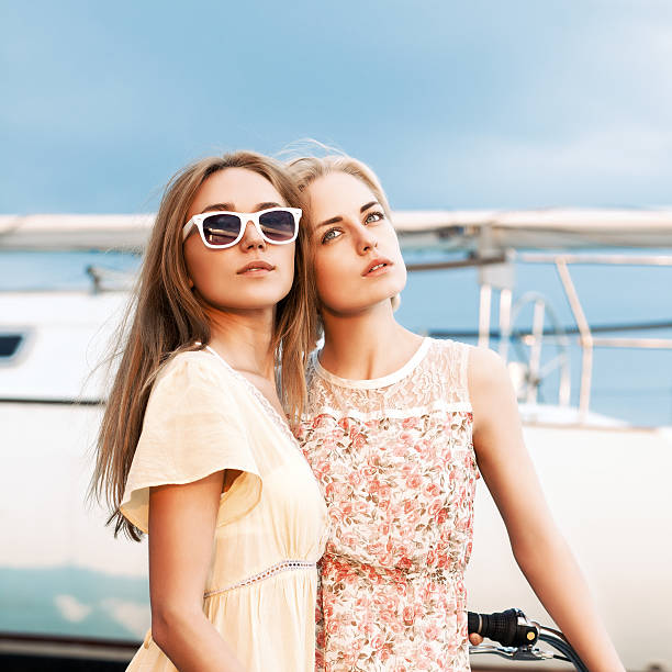 istock two beautiful girls at sea pier 508906965