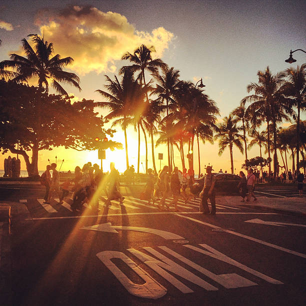 Waikiki beach sunset. people crossing street stock photo