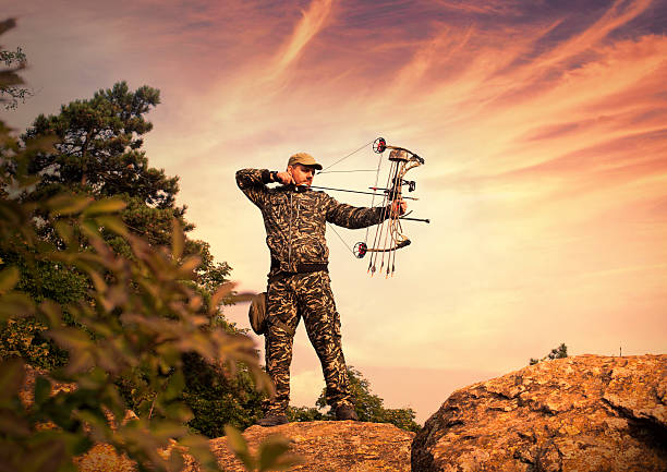 Profile of bowman with bow and arrow.