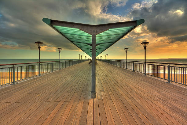 Boscombe Pier Boscombe Pier at sunset with brooding clouds boscombe photos stock pictures, royalty-free photos & images