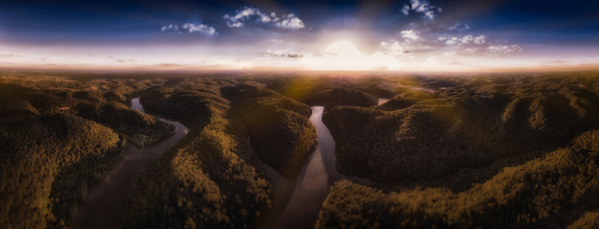 Sun settting across wilderness and river