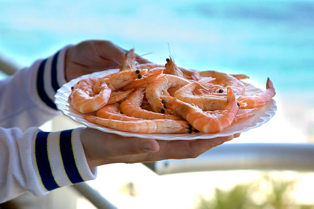 istock Waiter serves shrimps on the white plate. 508908489