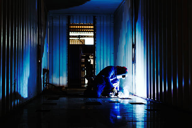 istock Steel fabrication plant: welder busy modifying cargo container 508909805