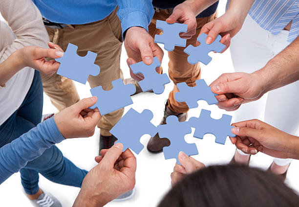 istock Group of people connecting puzzle pieces 508910113