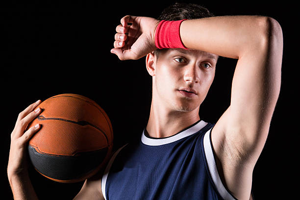 Basketball player wipes the sweat from his forehead stock photo