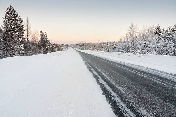 istock road in winter at dawn 508916018
