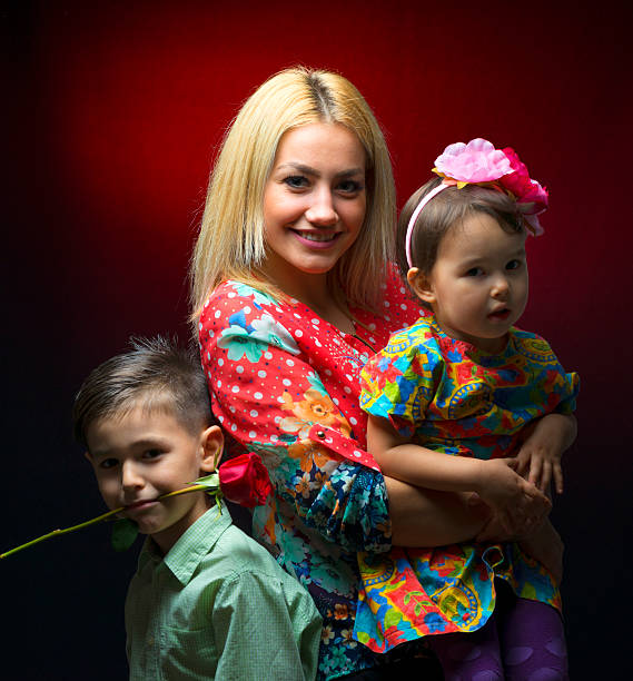 istock Mother with her two children isolated on black background 508916708
