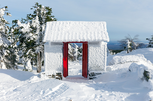 Snow-covered gate in a Buddhist temple on a mountain top