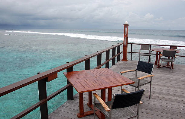 istock Open air cafe at timber platform with ocean view 508919116