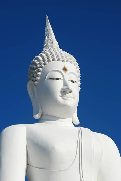 istock Big white buddha statue on blue sky background 508919964