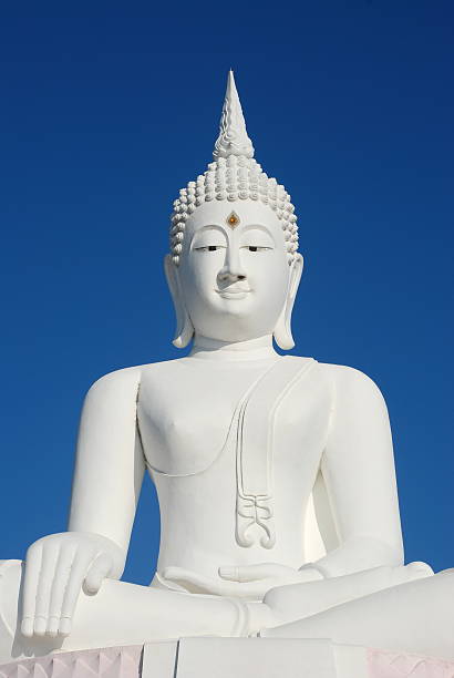 istock Big white buddha statue on blue sky background 508920012