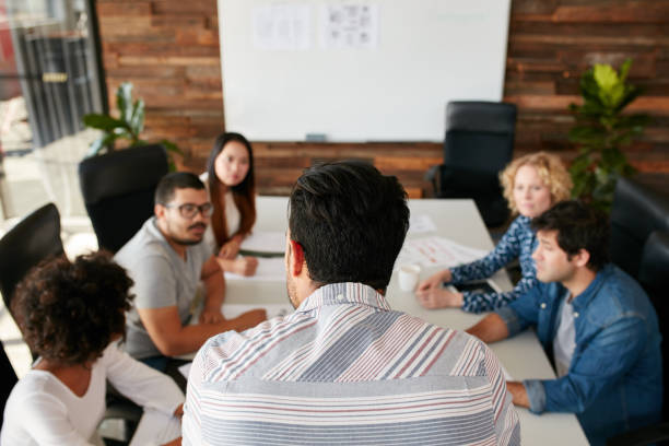 istock Man explaining business plan to coworkers 508920584