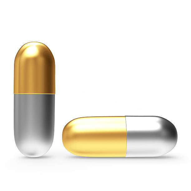 istock Golden and silver medical capsules 508920754