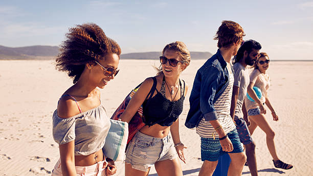 istock Group of young friends walking down a beach 508921304