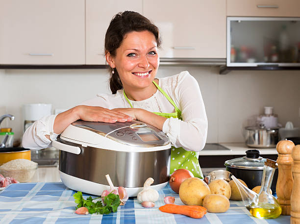 istock Happy  woman using slo-cooker 508921824