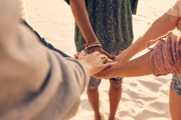 istock Friends at the beach putting hands together 508922154