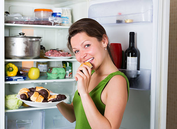 istock Woman eating cake from fridge 508922314