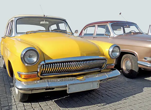 Retrocars of 1960s sedan on the cobbled pavement of the city central square at the parade of the vintage cars