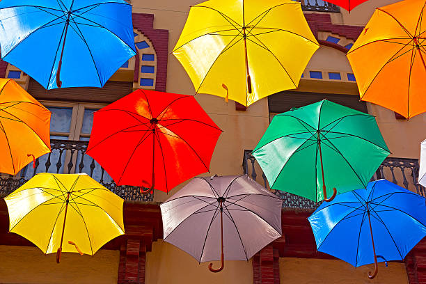 istock Floating umbrellas and city building on background. 508934557