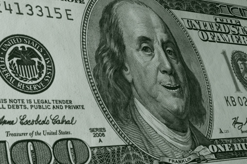 Hundred Dollar Bill seen close up and leaning, in perspective, with a smiling, happy Ben Franklin